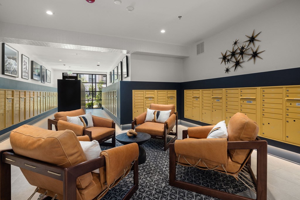 a lounge area with couches and chairs and lockers