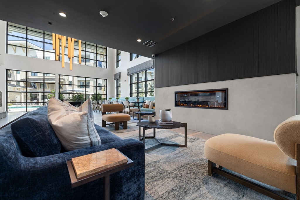 a living room with couches and chairs and a fireplace