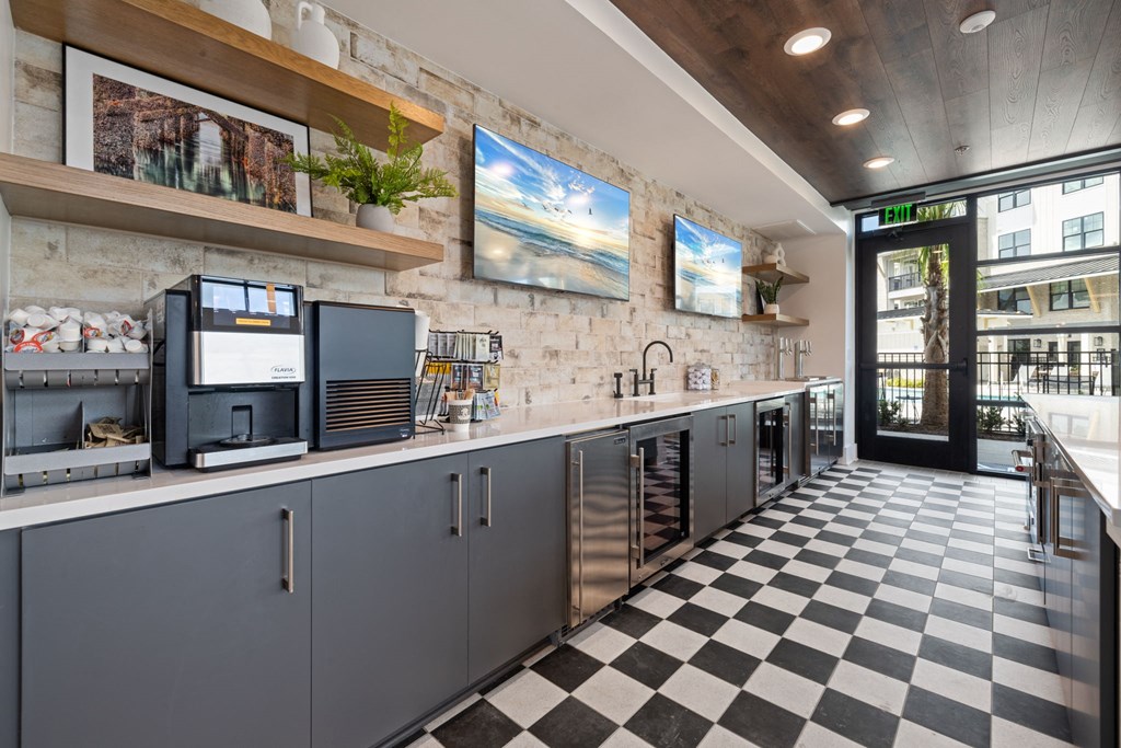 a kitchen with a checkered floor and a counter with coffee machines