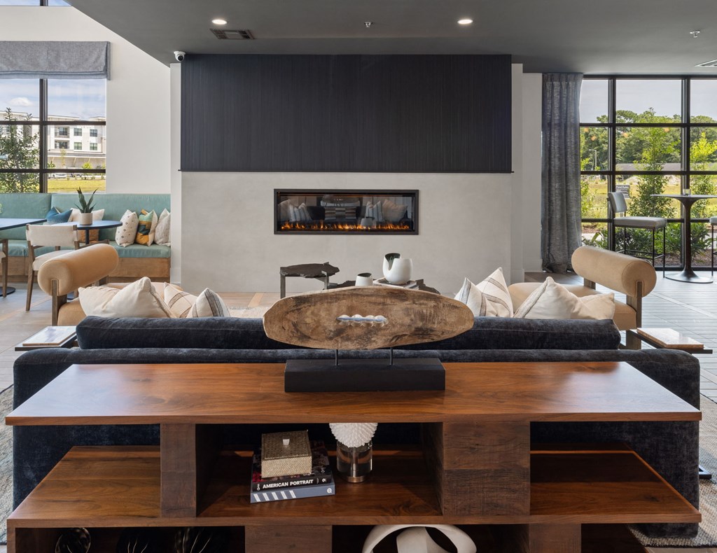 a living room with a couch and a table in front of a fireplace