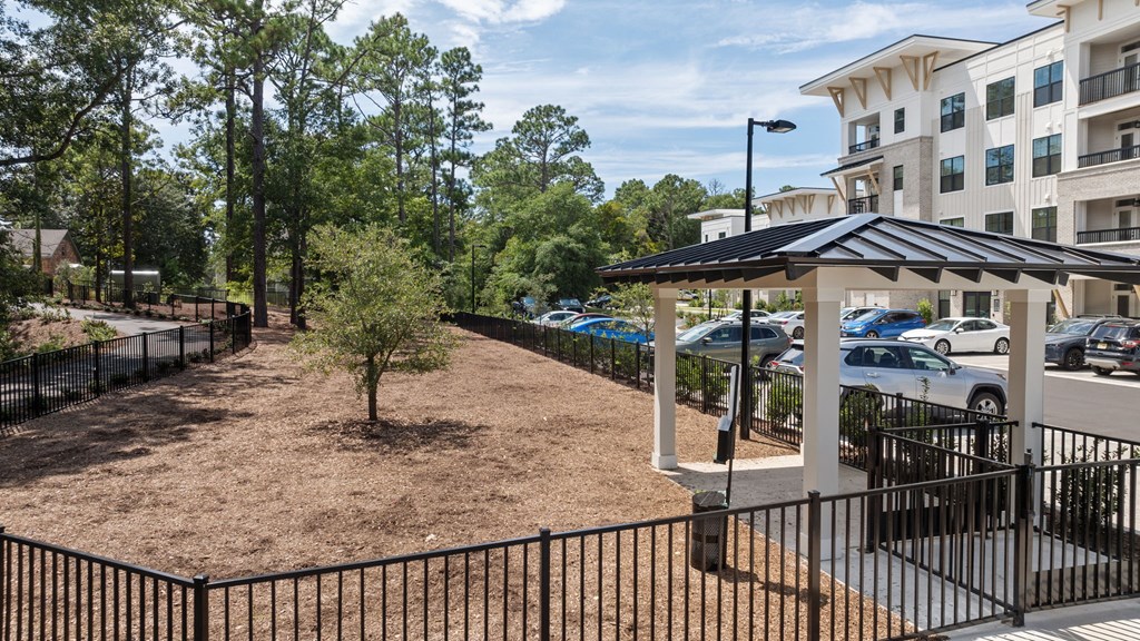 a park with a gazebo and a parking lot