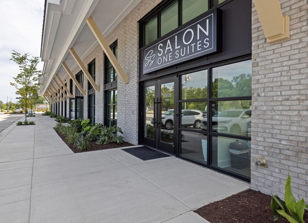 the exterior of a salon one suites building with glass doors