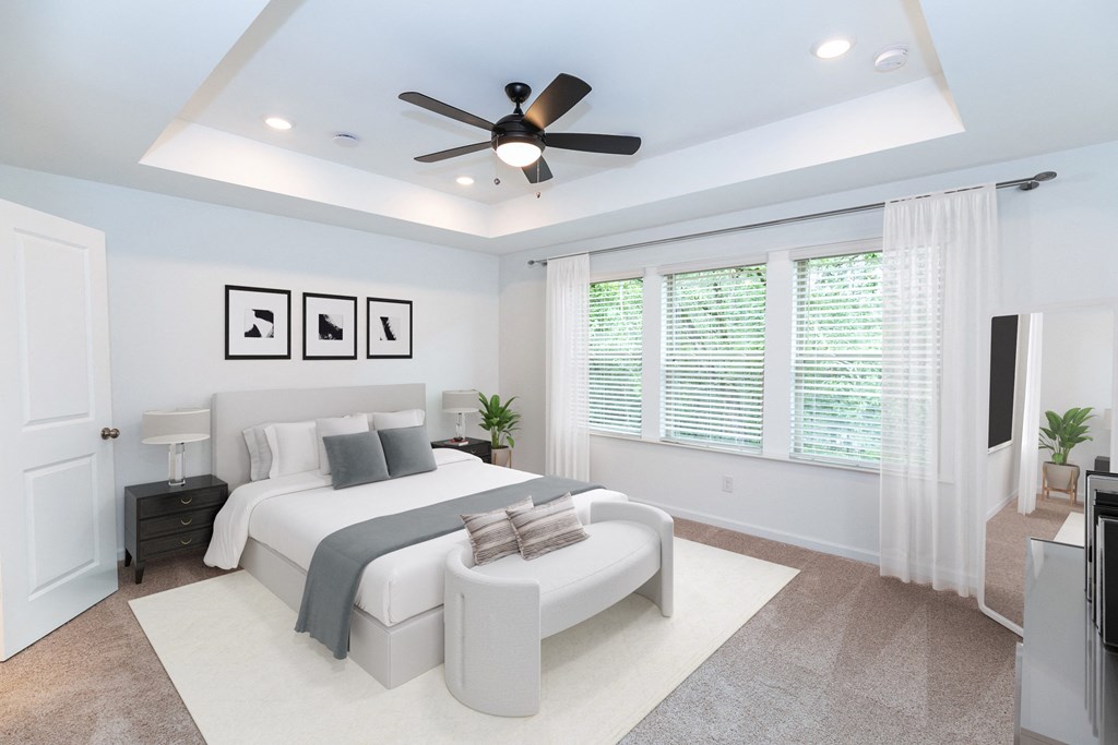 a bedroom with a large bed and a ceiling fan