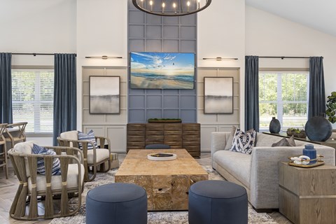 A living room with a large painting on the wall and a wooden coffee table in the center.