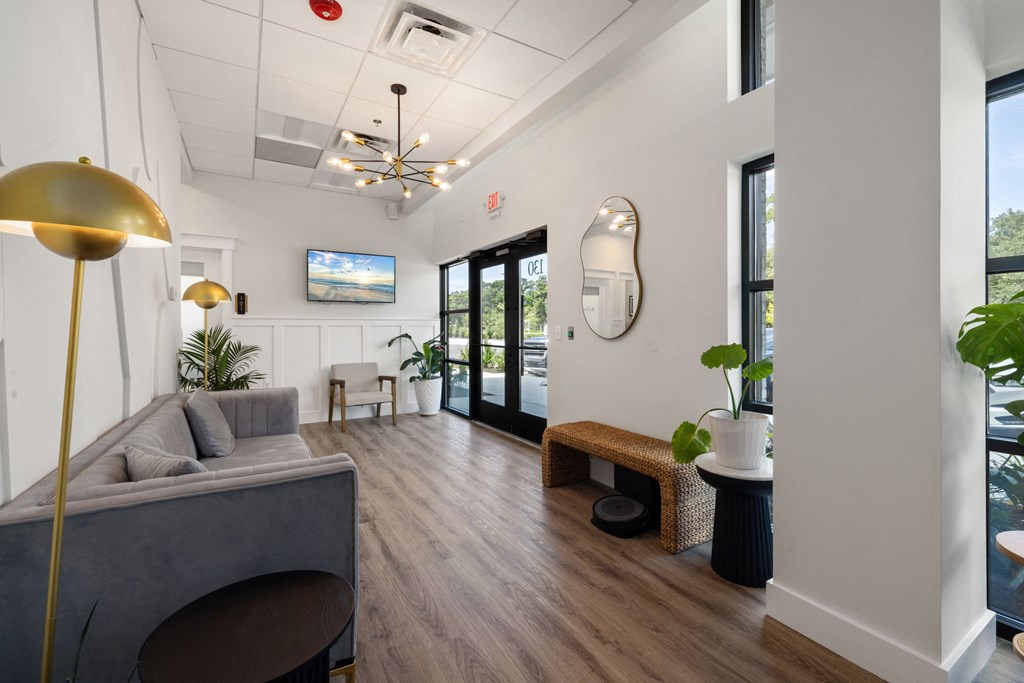 a view of a large lobby with tables and chairs and windows
