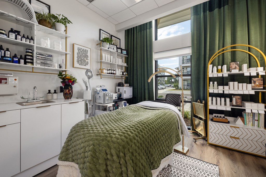 A spa room with a massage table and shelves of products.