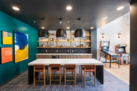 A modern kitchen with a long table and chairs.