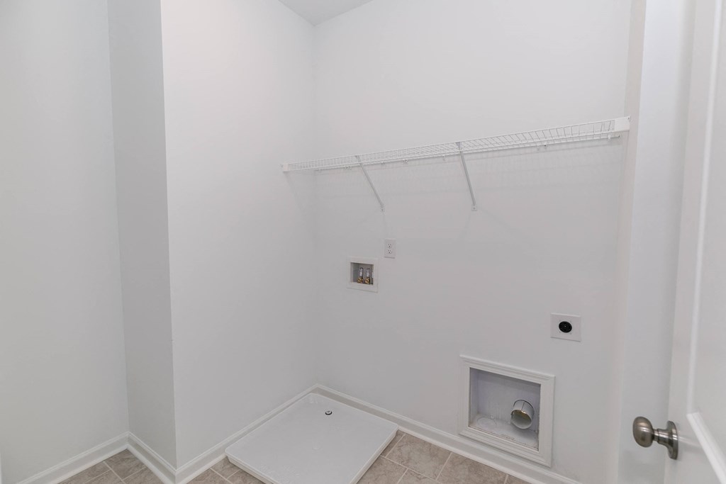 a bathroom with white walls and a white shower
