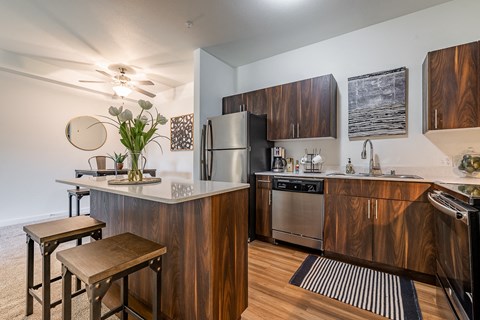 a kitchen with stainless steel appliances and a counter top with wooden cabinets
