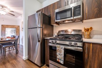 a kitchen with stainless steel appliances and wooden cabinets