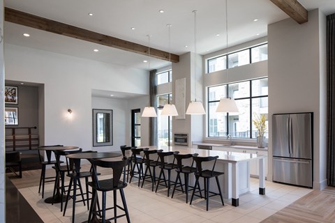 A modern kitchen with a dining table and chairs.