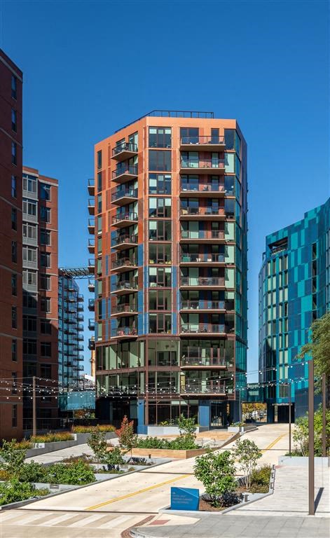 the facade of the building is surrounded by tall buildings