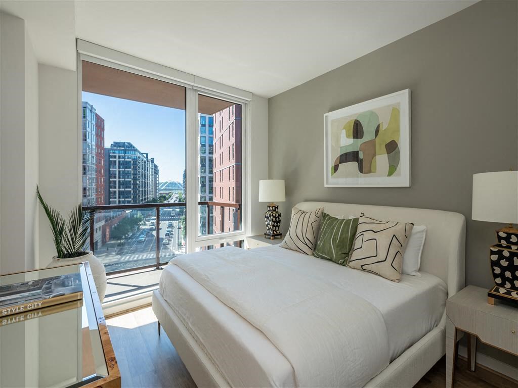 a bedroom with a bed and a large window