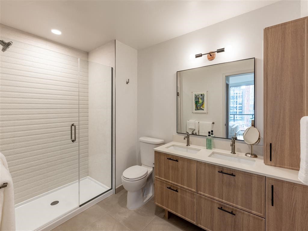 a bathroom with a shower toilet and a sink