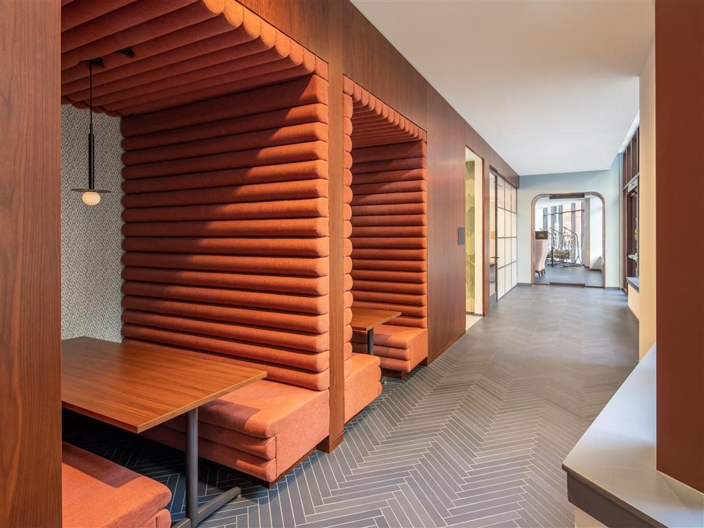 a long hallway with benches and a wooden wall