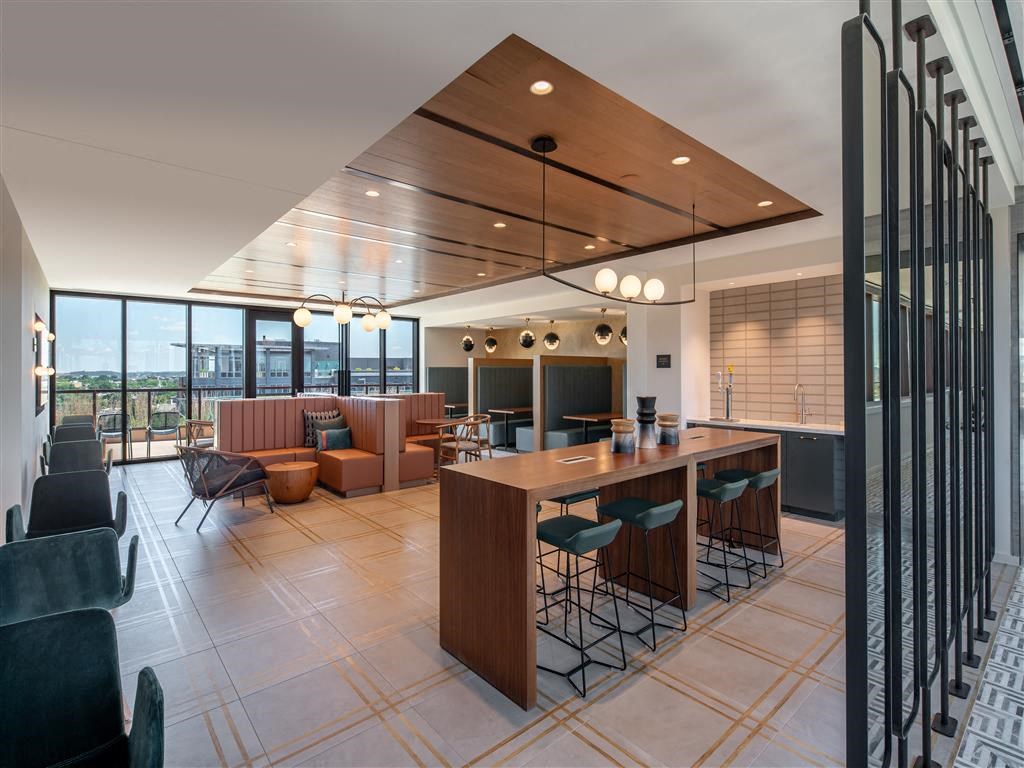 a large kitchen and living room with a table and chairs