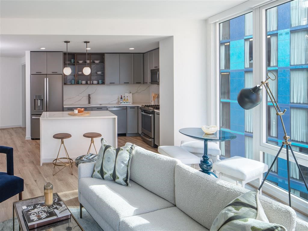 Living area looking into open-concept kitchen