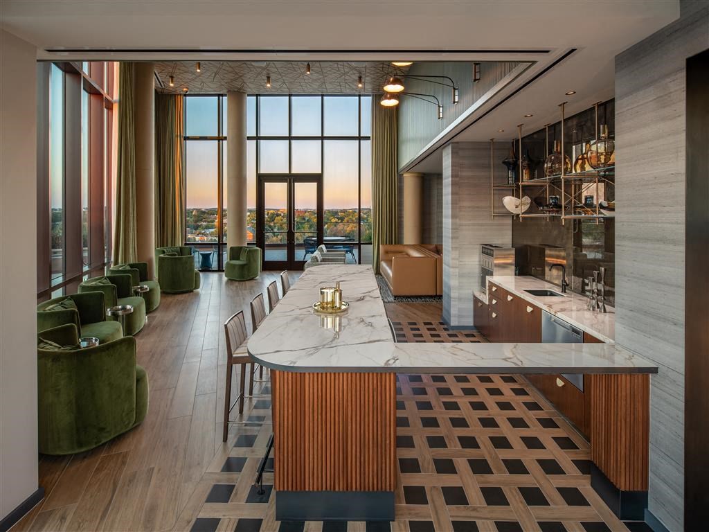 a kitchen with a marble counter top and a table with chairs