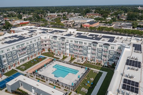 an aerial view of a large apartment building with a swimming pool