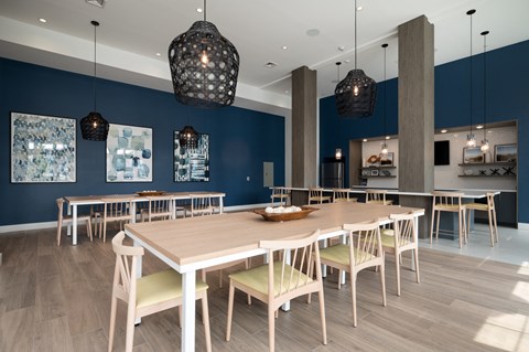 a dining room with blue walls and a long wooden table and chairs