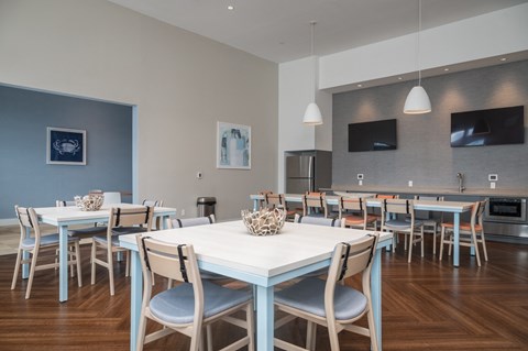 a dining room with tables and chairs and a television