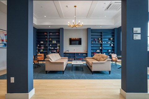a living room with couches and chairs and a television