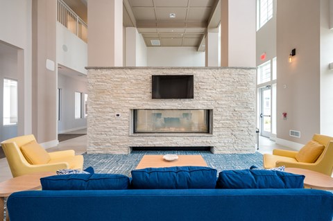 a living room with a blue couch and a fireplace