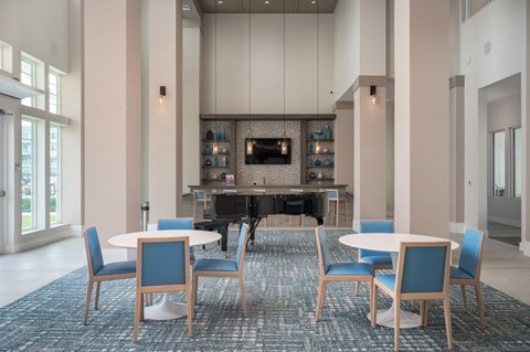 a conference room with tables and chairs and a piano