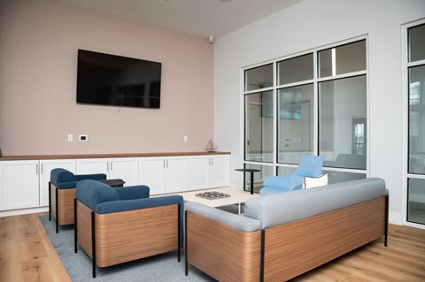 a living room with couches and chairs and a television