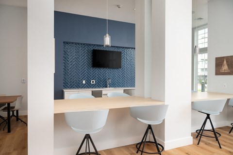 a dining area with a table and chairs and a television