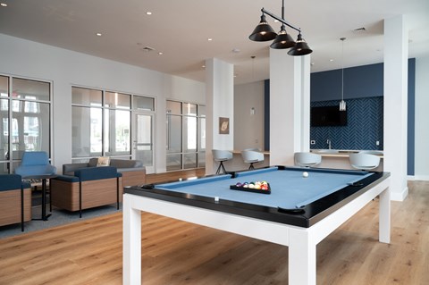 a living room with a pool table and a tv