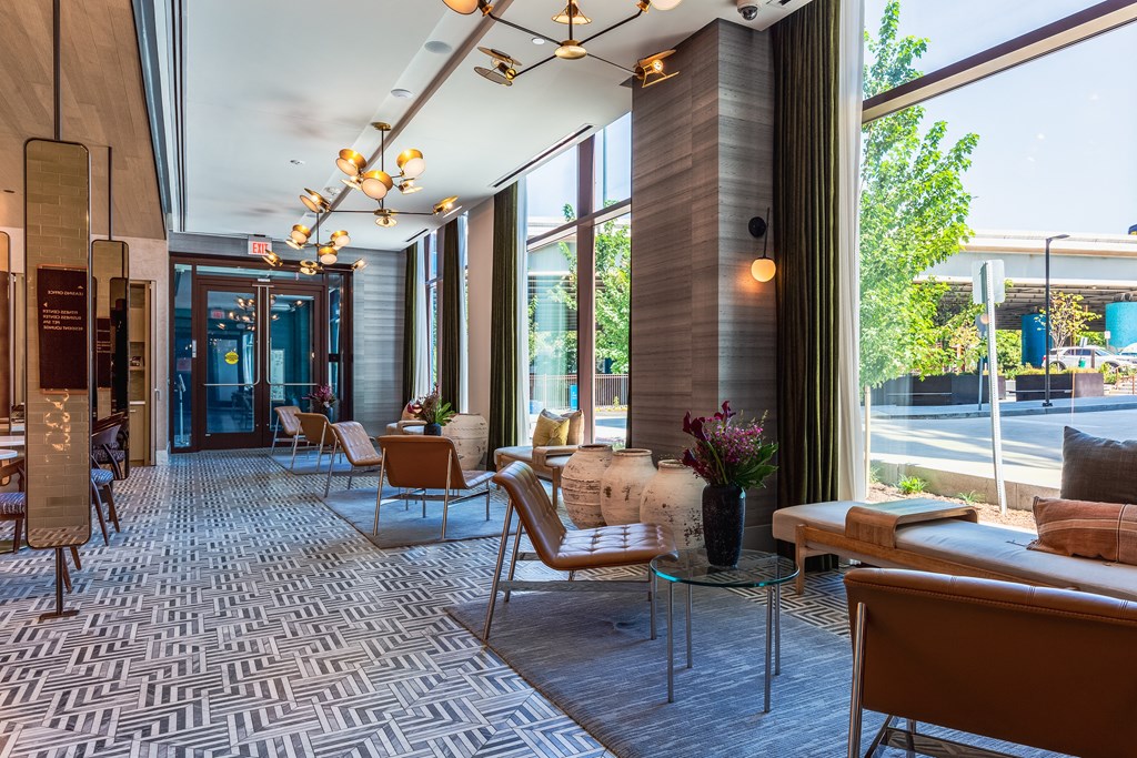 A modern living room with a glass table and chairs.