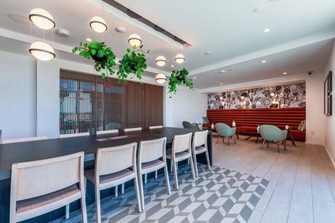 A dining room with a long table and chairs.