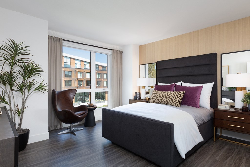 a bedroom with a bed and a chair in a 555 waverly unit