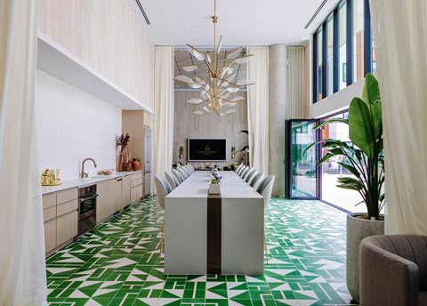 a room with a long table and a chandelier