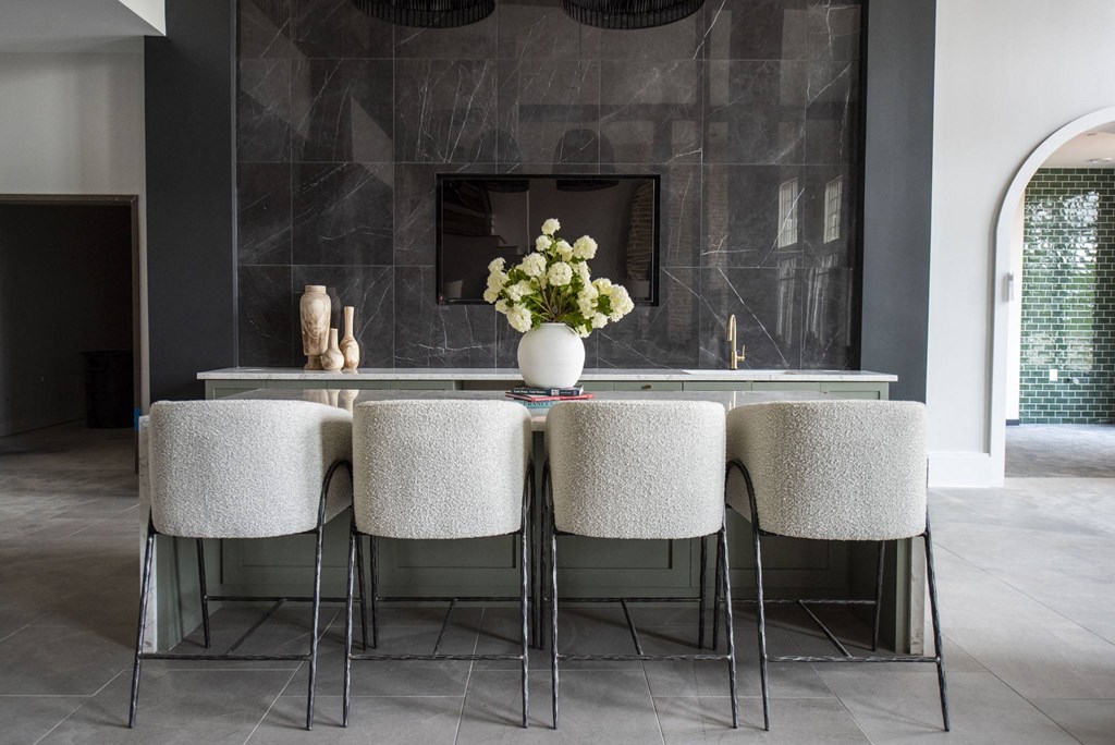Resident Lounge with table with chairs and a vase of flowers