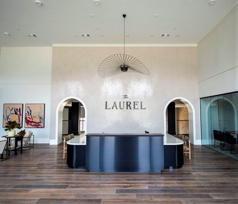 a large lobby with a blue front desk and a chandelier