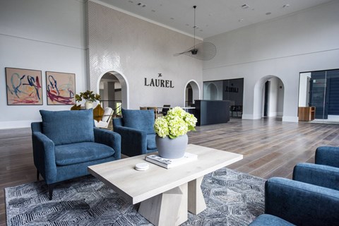 a living room with blue chairs and a coffee table