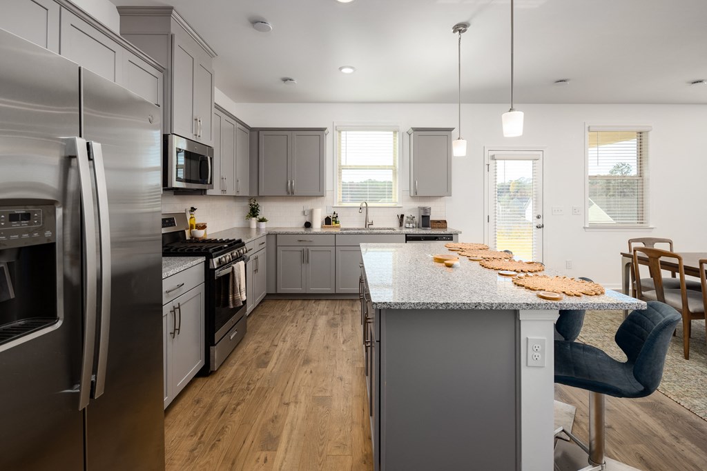 a kitchen with stainless steel appliances and a marble counter top