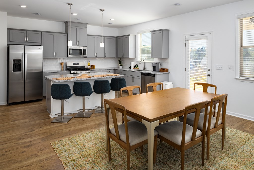 an open kitchen and dining room with a table and chairs