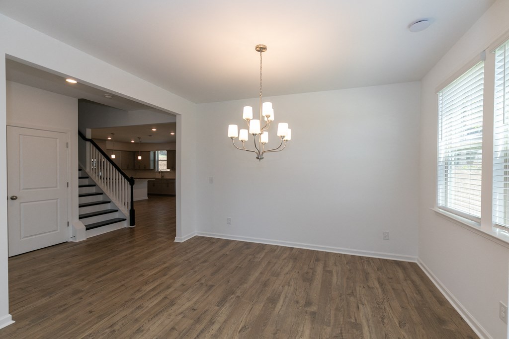 an empty living room with a chandelier