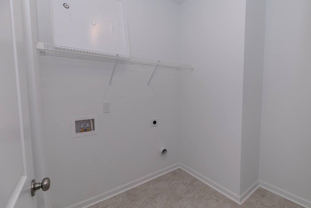 a bedroom with a white wall and a white door