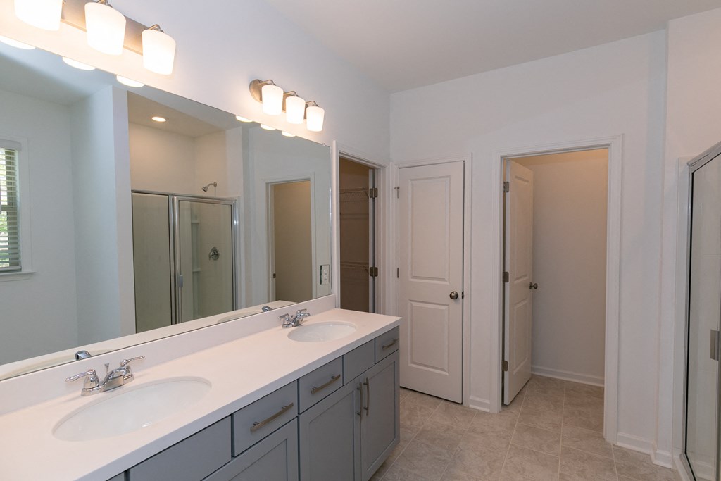a bathroom with a large mirror and two sinks