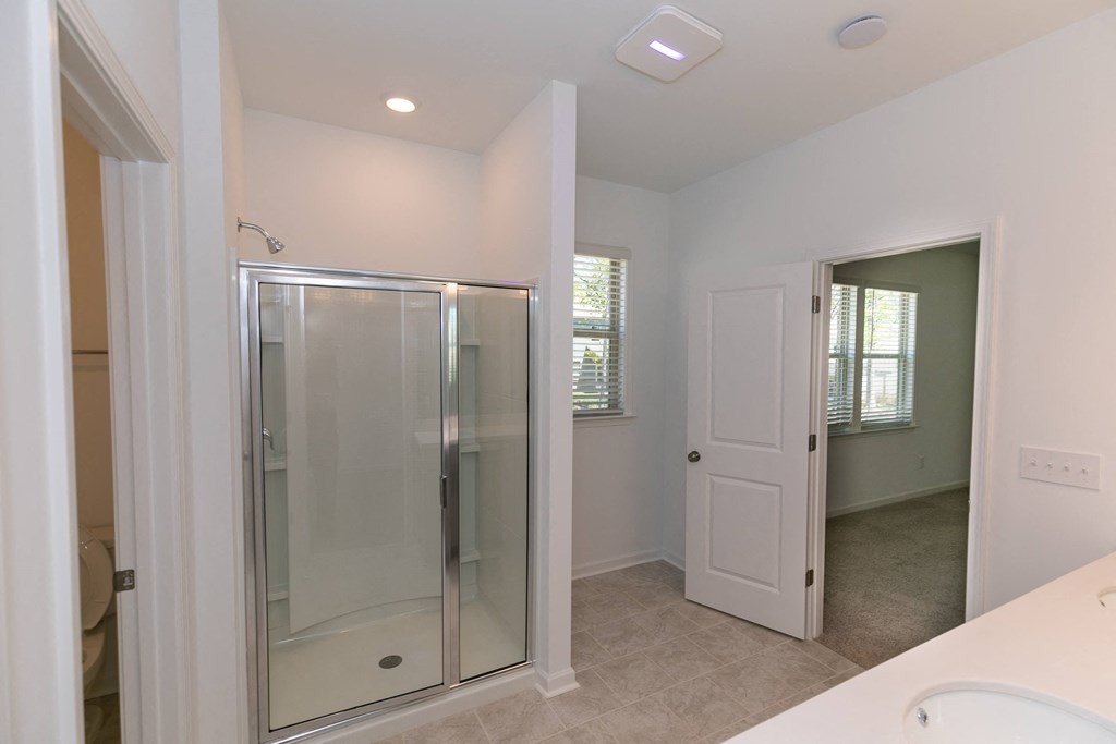 a bathroom with a shower and a sink