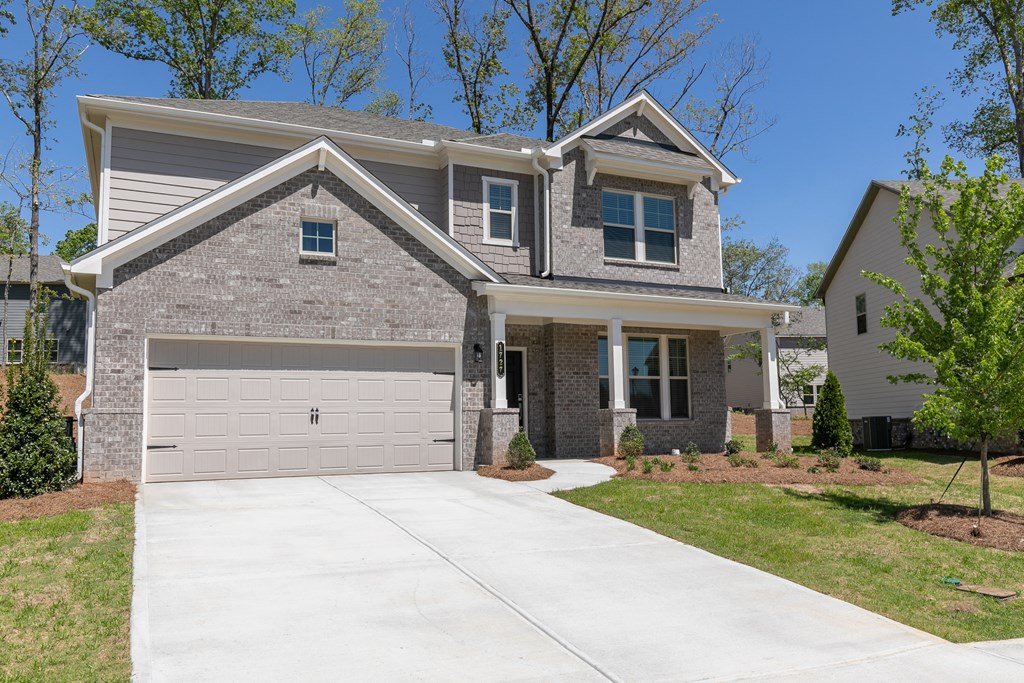 a house with a concrete driveway and a garage door