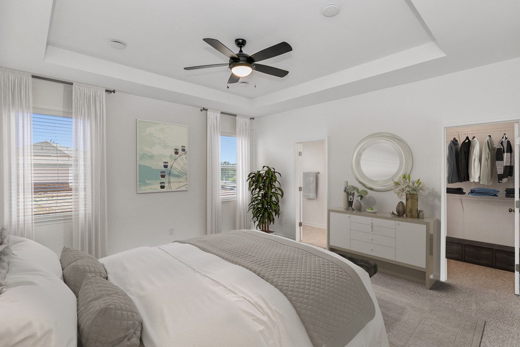 a bedroom with a large bed and a ceiling fan