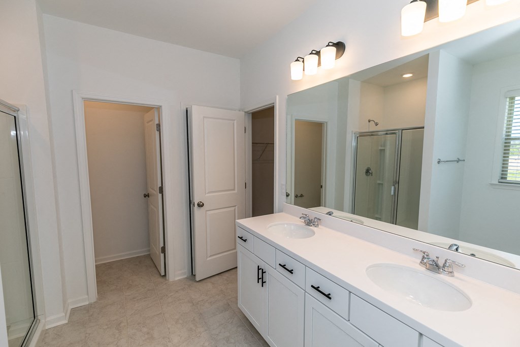 a bathroom with a large mirror and two sinks
