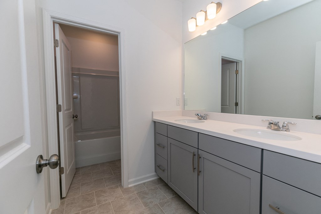 a bathroom with a large mirror and two sinks