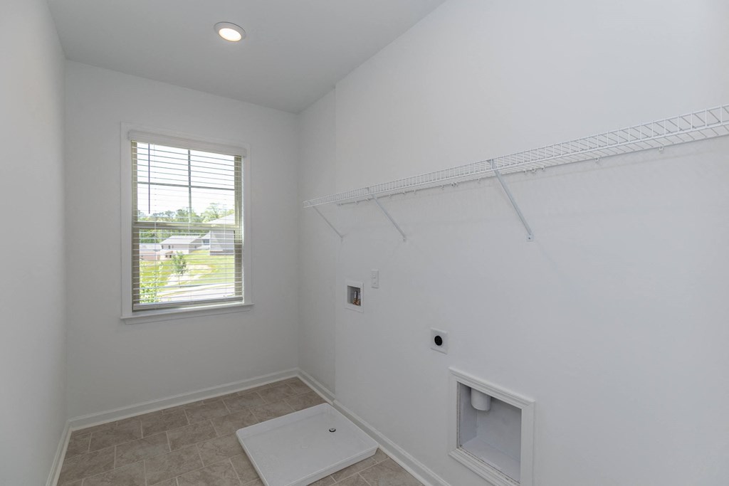 a bathroom with white walls and a window