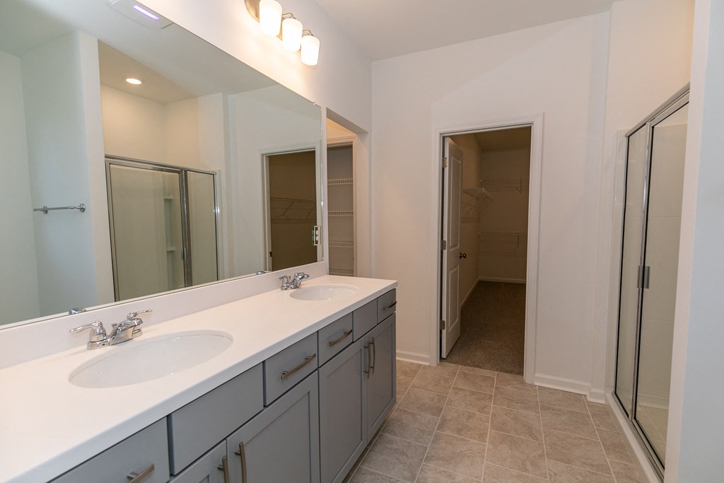 a bathroom with a large mirror and two sinks